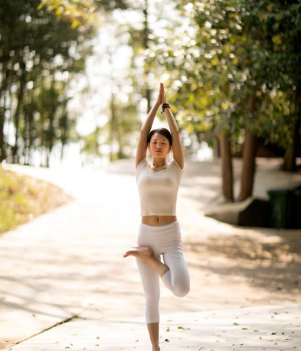 Woman in a calm yoga pose, embodying harmony and stability.